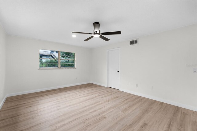 7085 Willowwood St, Orlando, FL 32818 - unfurnished room with light wood finished floors, a ceiling fan, and baseboards
