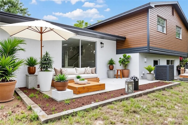 7085 Willowwood St, Orlando, FL 32818 - back of house featuring stucco siding and a patio area
