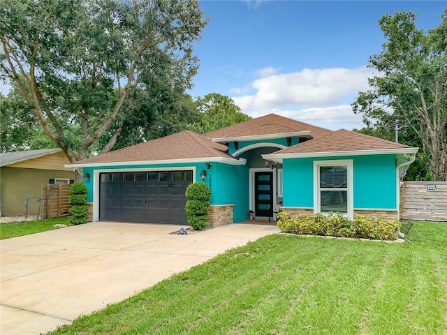 view of front facade with an attached garage, stone siding, driveway, stucco siding, and roof with shingles