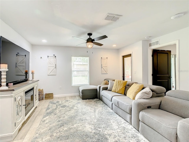 living area with a ceiling fan, baseboards, light wood-style floors, and recessed lighting