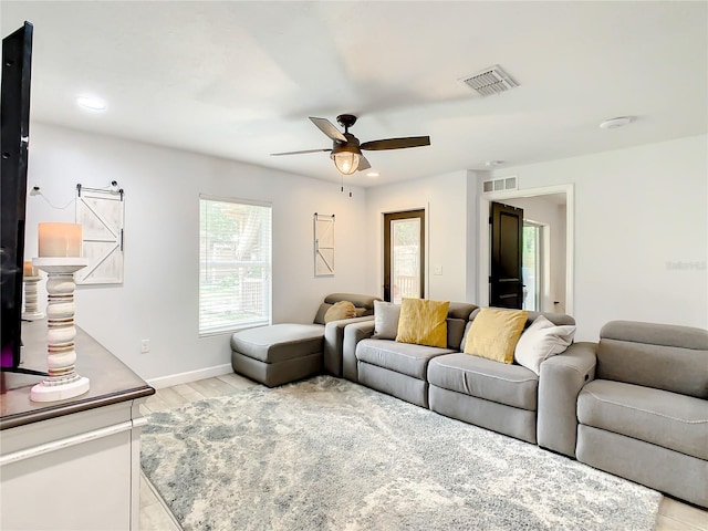 living room with ceiling fan, baseboards, light wood-type flooring, and recessed lighting