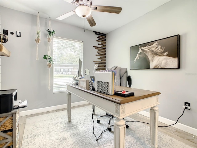 office with ceiling fan and baseboards