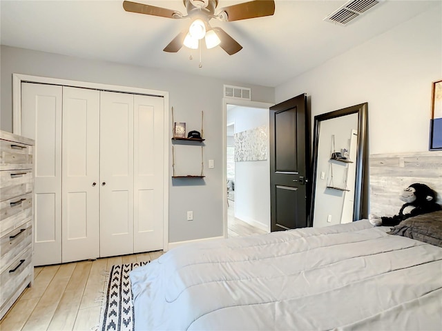 bedroom featuring light wood-type flooring, a closet, and a ceiling fan