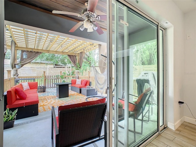 view of patio featuring fence, an outdoor living space, and ceiling fan