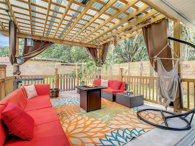 view of patio / terrace featuring an outdoor living space with a fire pit, a fenced backyard, and a pergola