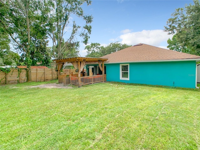 back of property with a pergola, roof with shingles, and a patio area