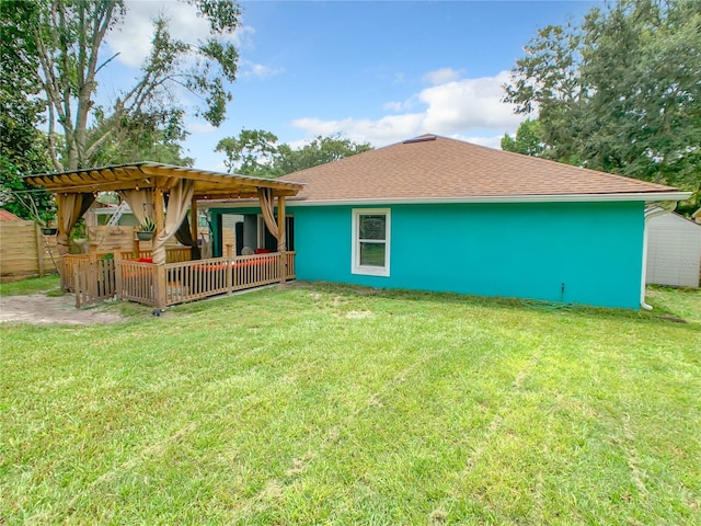 rear view of property with a shingled roof
