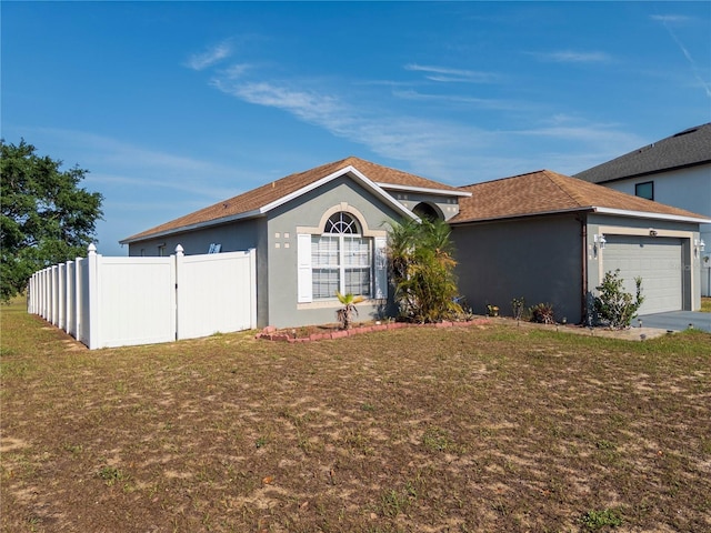 212 Ashford Dr, Davenport, FL 33837 - ranch-style home featuring stucco siding, an attached garage, and roof with shingles