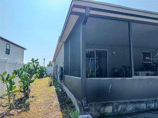 212 Ashford Dr, Davenport, FL 33837 - view of side of property with fence and a sunroom