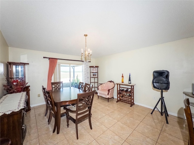 212 Ashford Dr, Davenport, FL 33837 - dining room featuring a chandelier, light tile patterned floors, and baseboards