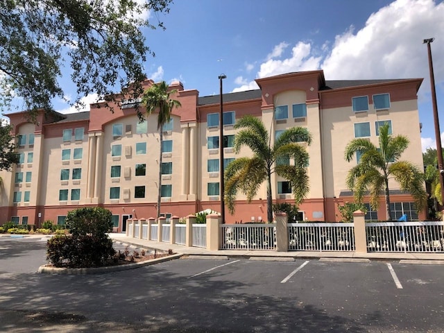 view of building exterior featuring uncovered parking