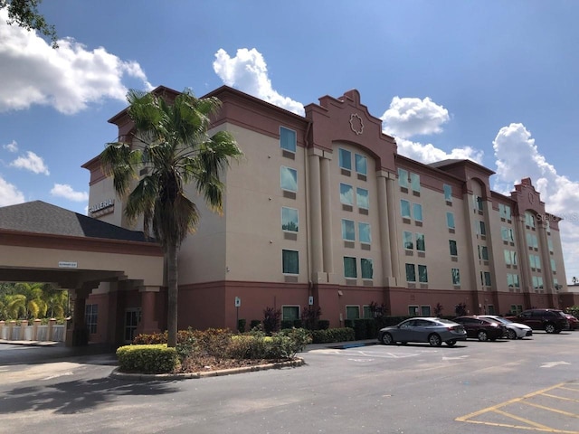 view of property featuring uncovered parking