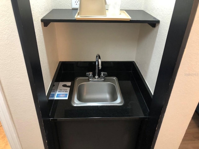 kitchen with a sink and a textured wall