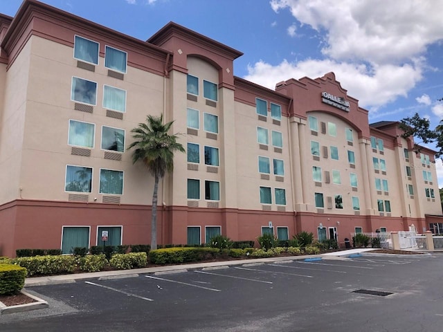 view of property featuring uncovered parking