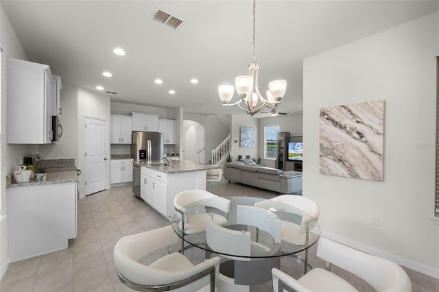 16484 Angel Fish Rd, Winter Garden, FL 34787 - dining space featuring arched walkways, recessed lighting, a chandelier, baseboards, and light tile patterned floors