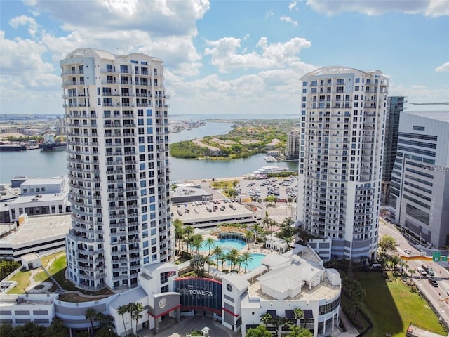 view of urban area with a nearby body of water and a pool