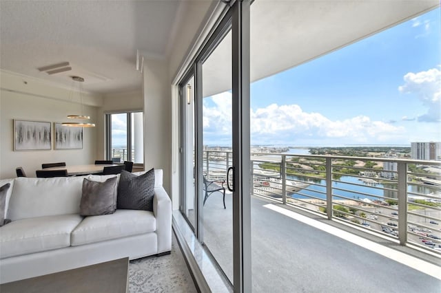 living area with a water view and dark speckled floor