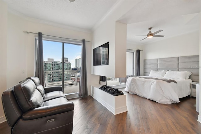 bedroom featuring access to exterior, crown molding, dark wood-style flooring, ceiling fan, and a view of city