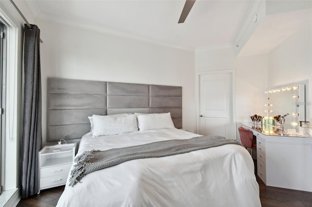 bedroom featuring ornamental molding, dark wood-style floors, and a ceiling fan