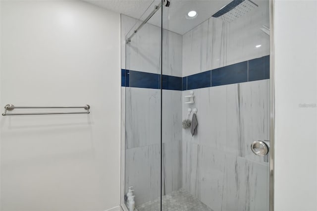 full bathroom with a marble finish shower