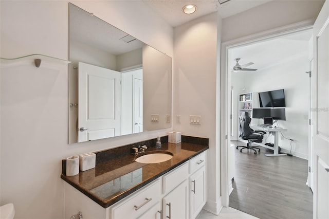 bathroom with vanity, recessed lighting, baseboards, a ceiling fan, and wood finished floors