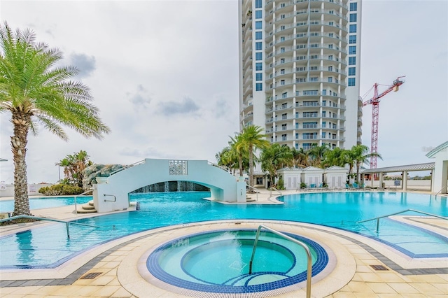 community pool with a hot tub