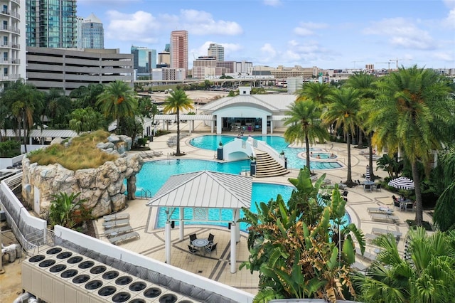 community pool featuring a patio and a view of skyline