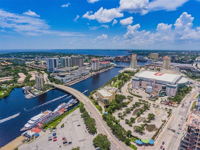 view of urban area featuring a large body of water, a notable bridge, and a major roadway