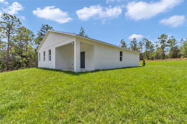 12197 SW 76th Ln, Dunnellon, FL 34432 - view of side of property with stucco siding and a lawn