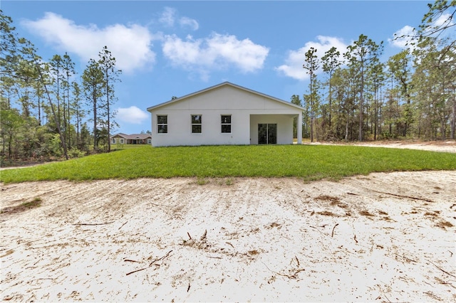12197 SW 76th Ln, Dunnellon, FL 34432 - view of side of home featuring a yard