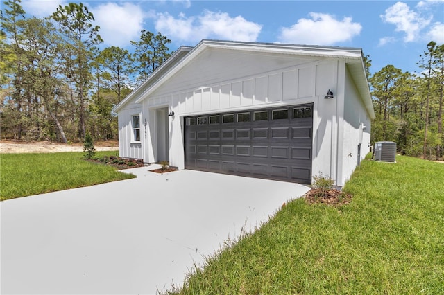 12197 SW 76th Ln, Dunnellon, FL 34432 - view of home's exterior featuring board and batten siding, a lawn, cooling unit, and concrete driveway