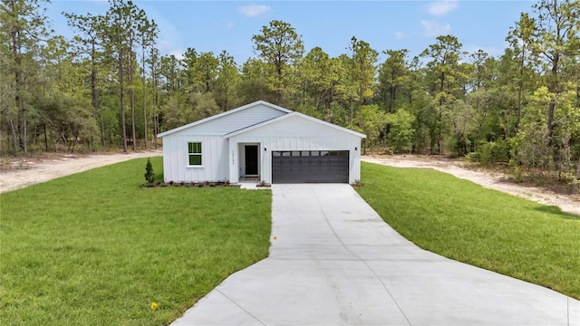 12197 SW 76th Ln, Dunnellon, FL 34432 - view of front facade featuring board and batten siding, a front lawn, driveway, and a wooded view
