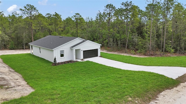 12197 SW 76th Ln, Dunnellon, FL 34432 - modern farmhouse style home featuring concrete driveway, a garage, a front lawn, board and batten siding, and a view of trees
