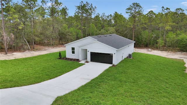 12197 SW 76th Ln, Dunnellon, FL 34432 - view of front of home featuring a view of trees, central AC, a front lawn, and roof with shingles