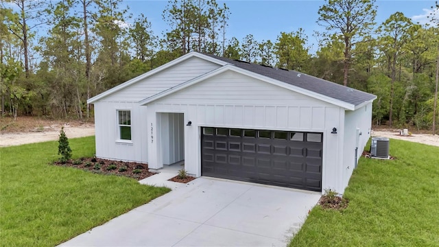 12197 SW 76th Ln, Dunnellon, FL 34432 - modern inspired farmhouse with central air condition unit, board and batten siding, a front lawn, and driveway