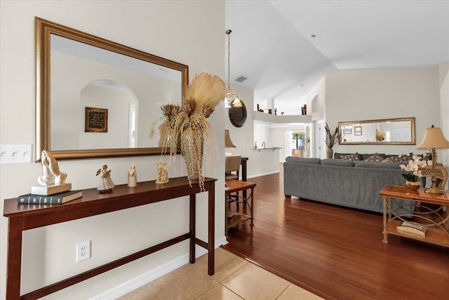 14617 Keelford Way, Orlando, FL 32824 - hall featuring lofted ceiling, arched walkways, and wood finished floors