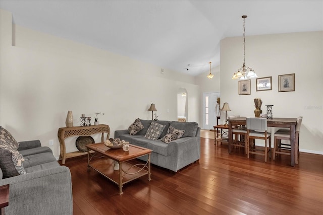 14617 Keelford Way, Orlando, FL 32824 - living room featuring lofted ceiling, dark wood-type flooring, and a chandelier