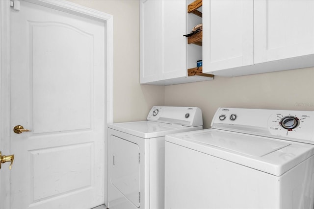 14617 Keelford Way, Orlando, FL 32824 - washroom with washing machine and dryer and cabinet space