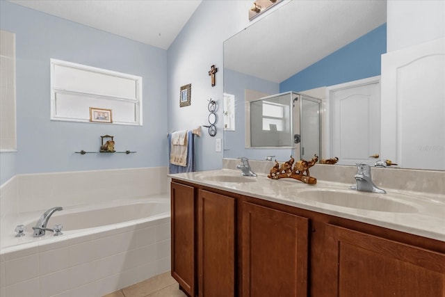 14617 Keelford Way, Orlando, FL 32824 - full bathroom with a bath, a shower stall, lofted ceiling, double vanity, and tile patterned flooring