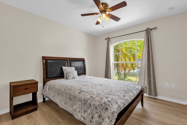 14617 Keelford Way, Orlando, FL 32824 - bedroom with light wood-style flooring, baseboards, and a ceiling fan