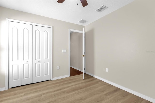 14617 Keelford Way, Orlando, FL 32824 - unfurnished bedroom featuring light wood-style floors, baseboards, a closet, and ceiling fan