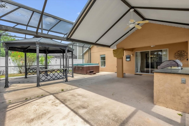 14617 Keelford Way, Orlando, FL 32824 - view of patio with a hot tub, glass enclosure, fence, and a gazebo