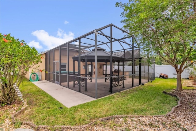 14617 Keelford Way, Orlando, FL 32824 - rear view of property featuring a patio, stucco siding, a gazebo, and glass enclosure