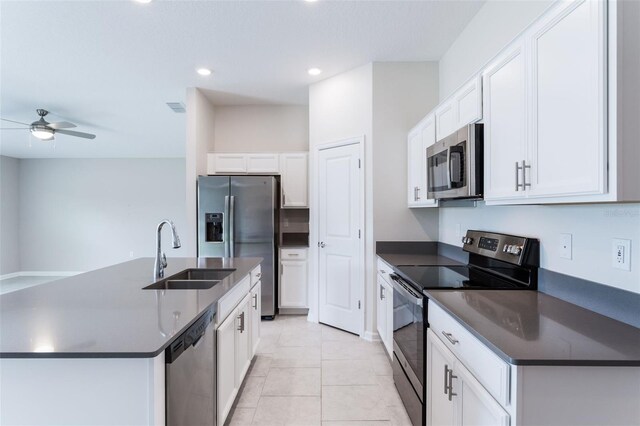 3971 Guernsey Bnd, Saint Cloud, FL 34772 - kitchen featuring appliances with stainless steel finishes, a sink, dark countertops, white cabinetry, and recessed lighting