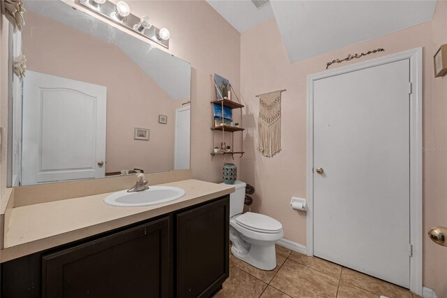 2330 Little Gem Loop, Sanford, FL 32773 - bathroom featuring vanity, tile patterned floors, toilet, and lofted ceiling