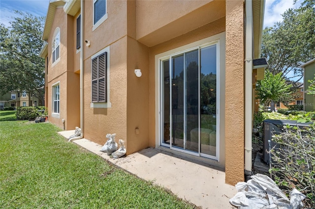 2330 Little Gem Loop, Sanford, FL 32773 - property entrance featuring stucco siding and a lawn