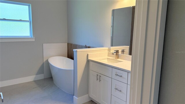 851 Marion Oaks Mnr, Ocala, FL 34473 - bathroom featuring a soaking tub, vanity, and baseboards