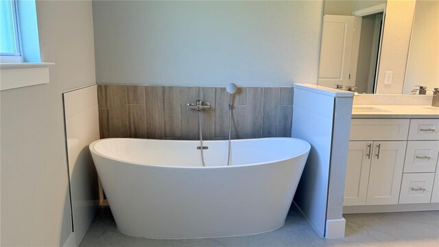 851 Marion Oaks Mnr, Ocala, FL 34473 - bathroom featuring vanity, tile walls, and a soaking tub