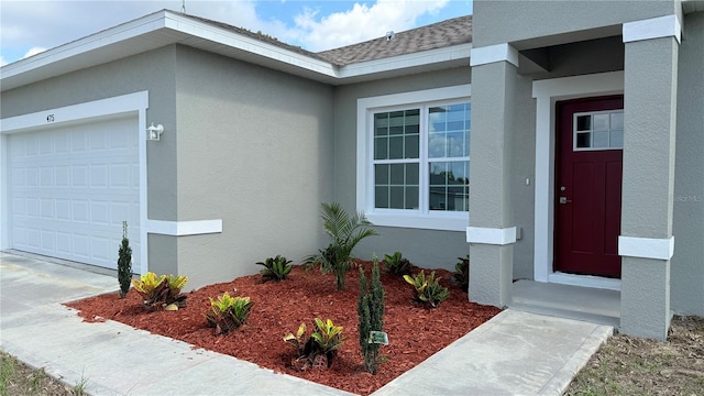 475 Marion Oaks Mnr, Ocala, FL 34473 - property entrance with an attached garage, stucco siding, and a shingled roof