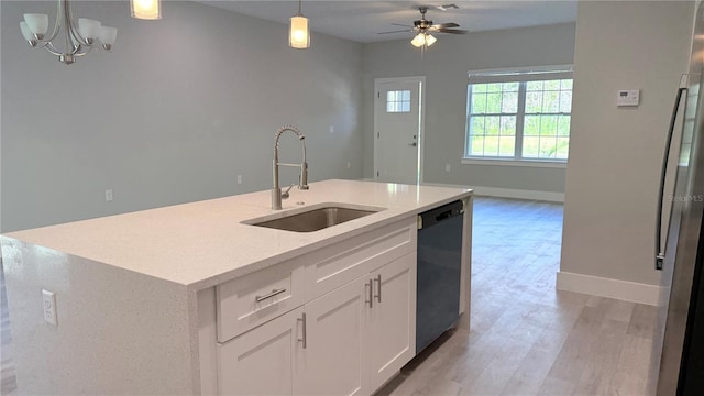 475 Marion Oaks Mnr, Ocala, FL 34473 - kitchen featuring a sink, dishwashing machine, open floor plan, pendant lighting, and light wood-type flooring